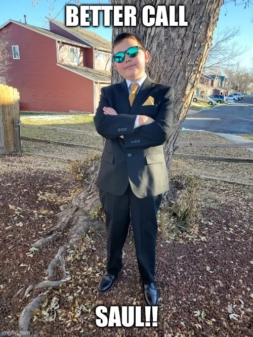 Sam's nephew in a suit and sunglasses